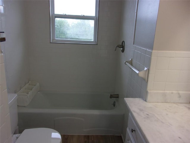 3018 N Beard Ave, Shawnee, OK 74804 - bathroom with vanity, bathing tub / shower combination, wood finished floors, and tile walls