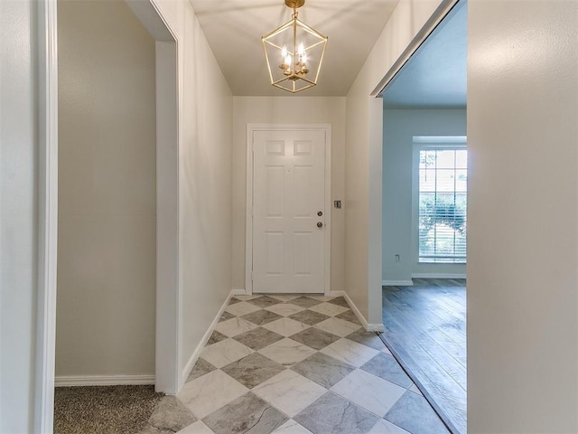 2317 NW 119th St, Oklahoma City, OK 73120 - foyer featuring a chandelier and baseboards