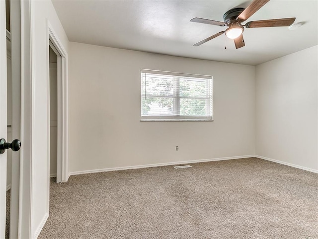 2317 NW 119th St, Oklahoma City, OK 73120 - spare room featuring carpet floors, ceiling fan, and a smoke detector