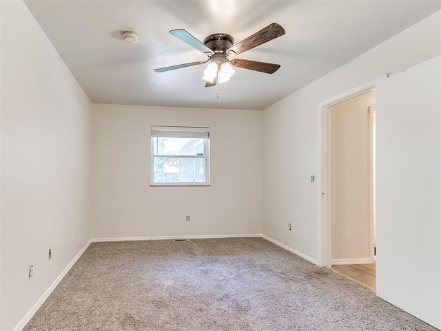 2317 NW 119th St, Oklahoma City, OK 73120 - carpeted empty room with a smoke detector and a ceiling fan