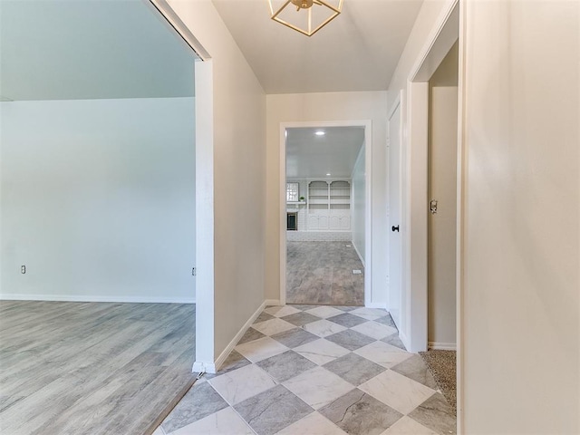 2317 NW 119th St, Oklahoma City, OK 73120 - corridor with baseboards and a chandelier
