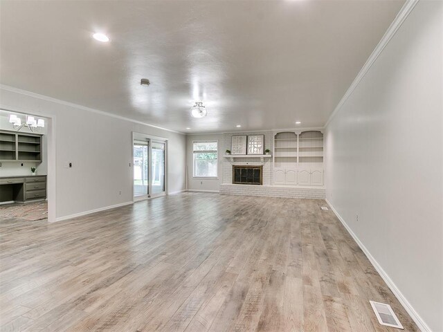 2317 NW 119th St, Oklahoma City, OK 73120 - unfurnished living room with light wood-style flooring, crown molding, a fireplace, and recessed lighting