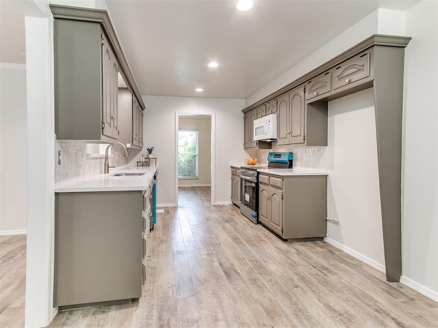 2317 NW 119th St, Oklahoma City, OK 73120 - kitchen featuring electric range, white microwave, recessed lighting, decorative backsplash, and light countertops