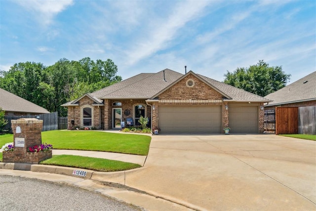 12409 Gaylon Cir, Oklahoma City, OK 73170 - view of front facade featuring brick siding, a garage, driveway, and roof with shingles