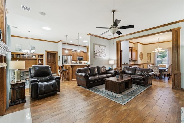 12409 Gaylon Cir, Oklahoma City, OK 73170 - living room featuring a chandelier, wood finished floors, a ceiling fan, and ornamental molding