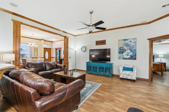 12409 Gaylon Cir, Oklahoma City, OK 73170 - living room with crown molding, a chandelier, light wood-style floors, a ceiling fan, and ornate columns