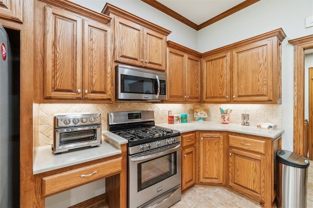 12409 Gaylon Cir, Oklahoma City, OK 73170 - kitchen featuring appliances with stainless steel finishes, backsplash, light countertops, brown cabinetry, and ornamental molding
