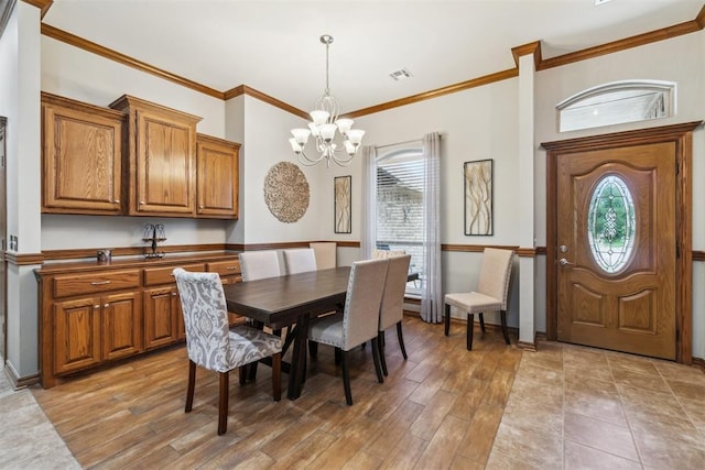 12409 Gaylon Cir, Oklahoma City, OK 73170 - dining room featuring a chandelier, ornamental molding, and light wood-style floors