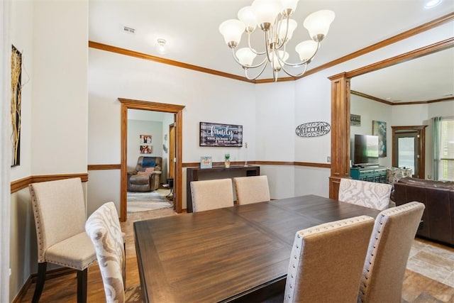12409 Gaylon Cir, Oklahoma City, OK 73170 - dining area with a chandelier, ornamental molding, and decorative columns