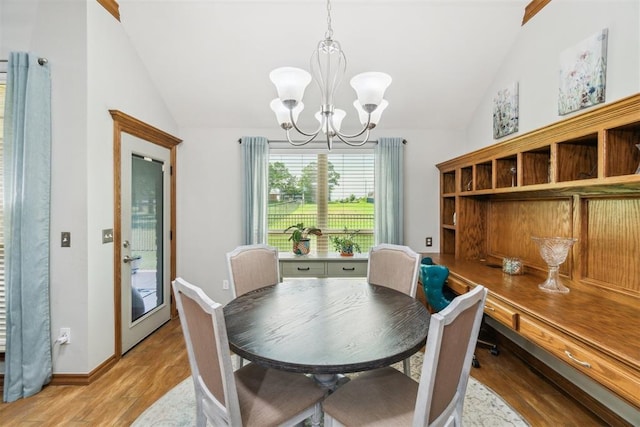 12409 Gaylon Cir, Oklahoma City, OK 73170 - dining room with vaulted ceiling, a chandelier, and light wood-style floors