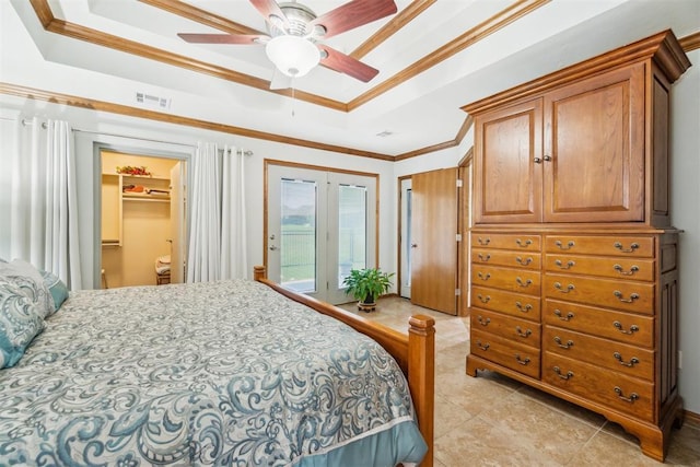 12409 Gaylon Cir, Oklahoma City, OK 73170 - bedroom featuring crown molding, access to exterior, a raised ceiling, light tile patterned flooring, and a spacious closet