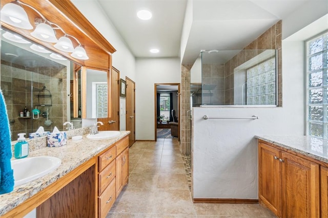 12409 Gaylon Cir, Oklahoma City, OK 73170 - bathroom with a tile shower, double vanity, and tile patterned flooring