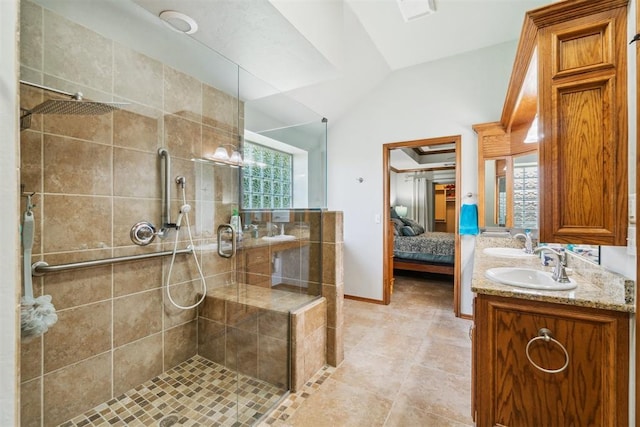 12409 Gaylon Cir, Oklahoma City, OK 73170 - ensuite bathroom featuring double vanity, a stall shower, lofted ceiling, and tile patterned flooring