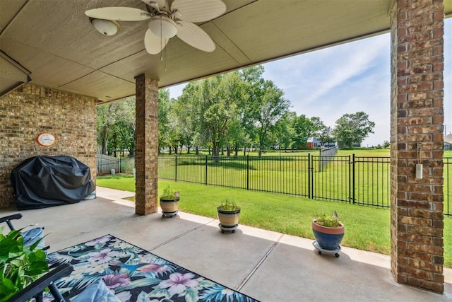 12409 Gaylon Cir, Oklahoma City, OK 73170 - fenced backyard featuring a grill, a patio area, and a ceiling fan