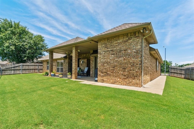 12409 Gaylon Cir, Oklahoma City, OK 73170 - back of house featuring a fenced backyard, brick siding, and a patio area