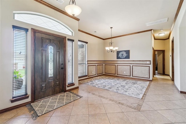 1600 SW 123rd St, Oklahoma City, OK 73170 - foyer featuring light tile patterned floors, ornamental molding, a chandelier, a decorative wall, and wainscoting
