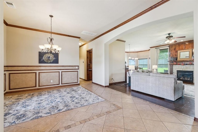 1600 SW 123rd St, Oklahoma City, OK 73170 - living room with ornamental molding, a chandelier, light tile patterned floors, arched walkways, and ceiling fan