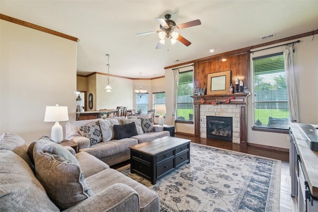 1600 SW 123rd St, Oklahoma City, OK 73170 - living area featuring plenty of natural light, crown molding, ceiling fan, a chandelier, and wood finished floors