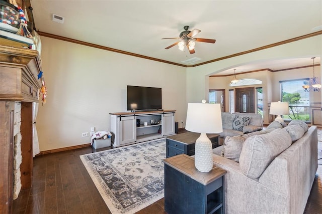 1600 SW 123rd St, Oklahoma City, OK 73170 - living room featuring ceiling fan, dark wood-style floors, ornamental molding, arched walkways, and a chandelier