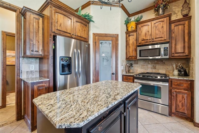 1600 SW 123rd St, Oklahoma City, OK 73170 - kitchen featuring appliances with stainless steel finishes, light tile patterned flooring, decorative backsplash, light stone counters, and crown molding