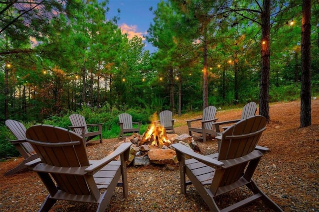 64 Mountain Alder Trl, Broken Bow, OK 74728 - patio terrace at dusk with a fire pit