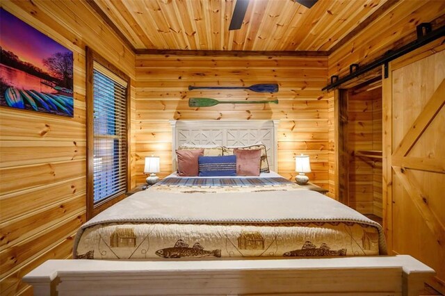 64 Mountain Alder Trl, Broken Bow, OK 74728 - bedroom with a barn door, wooden walls, and wooden ceiling