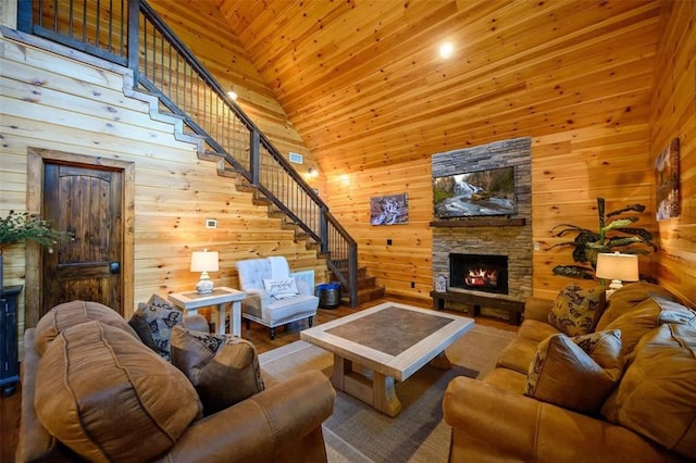 64 Mountain Alder Trl, Broken Bow, OK 74728 - living room featuring high vaulted ceiling, stairway, a stone fireplace, wood walls, and wood ceiling