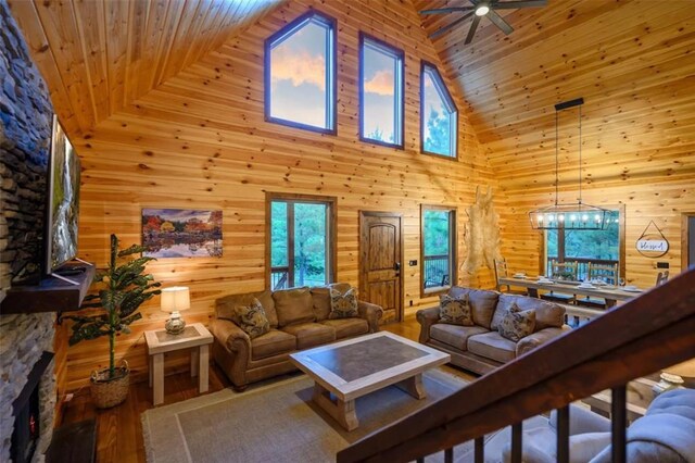 64 Mountain Alder Trl, Broken Bow, OK 74728 - living area with high vaulted ceiling, wooden ceiling, ceiling fan, wood finished floors, and wood walls