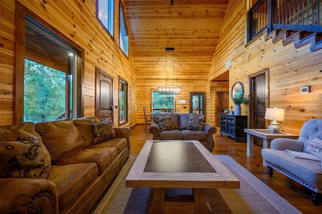 64 Mountain Alder Trl, Broken Bow, OK 74728 - living room featuring high vaulted ceiling, wood walls, wood finished floors, and a chandelier