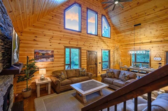 64 Mountain Alder Trl, Broken Bow, OK 74728 - living area with high vaulted ceiling, wood ceiling, ceiling fan, wood walls, and wood finished floors