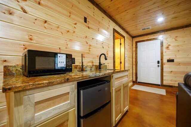 64 Mountain Alder Trl, Broken Bow, OK 74728 - indoor bar featuring refrigerator, black microwave, wood walls, wooden ceiling, and finished concrete floors