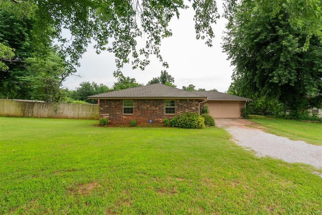 3414 Clayton Dr, Tuttle, OK 73089 - view of front facade with a garage, driveway, and brick siding