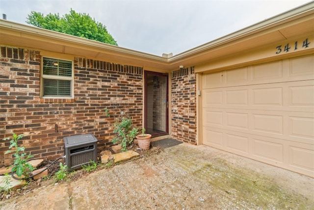 3414 Clayton Dr, Tuttle, OK 73089 - property entrance featuring driveway, brick siding, and a garage