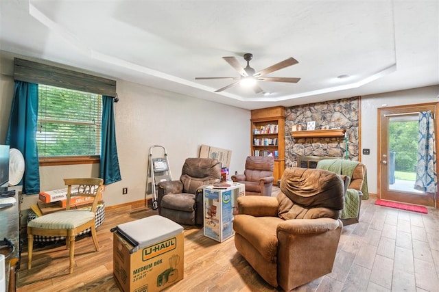3414 Clayton Dr, Tuttle, OK 73089 - living area with a tray ceiling, light wood-type flooring, and a ceiling fan