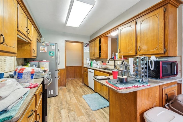 3414 Clayton Dr, Tuttle, OK 73089 - kitchen with black microwave, electric stove, dishwasher, brown cabinetry, and light wood-type flooring