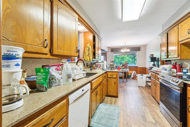 3414 Clayton Dr, Tuttle, OK 73089 - kitchen with dishwasher, electric range, wainscoting, light wood finished floors, and a chandelier