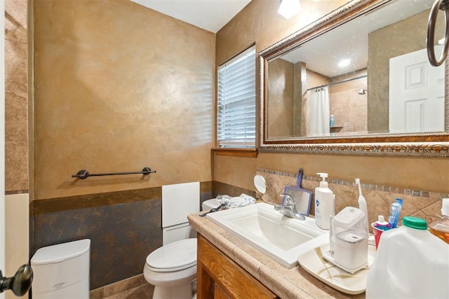 3414 Clayton Dr, Tuttle, OK 73089 - full bath featuring tile walls, vanity, a shower with shower curtain, and wainscoting
