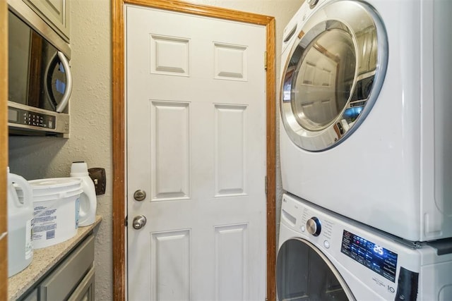 3414 Clayton Dr, Tuttle, OK 73089 - laundry room with stacked washer / dryer and a textured wall