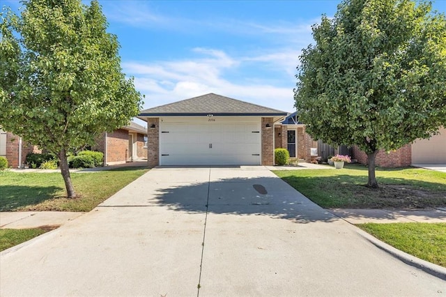 2336 NW 197th St, Edmond, OK 73012 - ranch-style home featuring driveway, a front yard, brick siding, and a garage