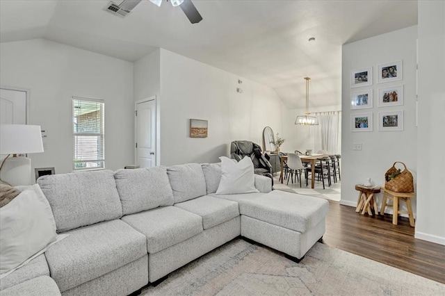 2336 NW 197th St, Edmond, OK 73012 - living area with lofted ceiling, a ceiling fan, wood finished floors, and a chandelier