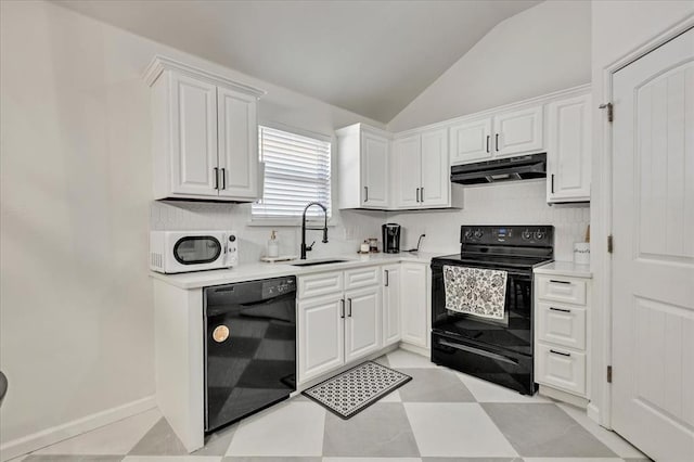 2336 NW 197th St, Edmond, OK 73012 - kitchen with black appliances, under cabinet range hood, vaulted ceiling, white cabinetry, and light countertops