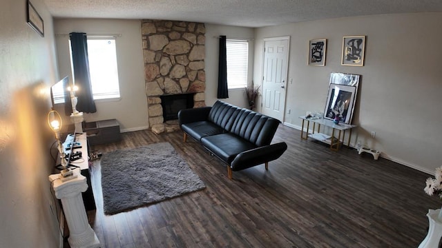 2628 N Ann Arbor Ave Unit 102, Oklahoma City, OK 73127 - living room with a fireplace, wood finished floors, and a textured ceiling