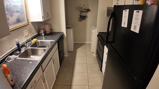 2628 N Ann Arbor Ave Unit 102, Oklahoma City, OK 73127 - kitchen with black appliances, white cabinetry, light tile patterned floors, separate washer and dryer, and dark countertops