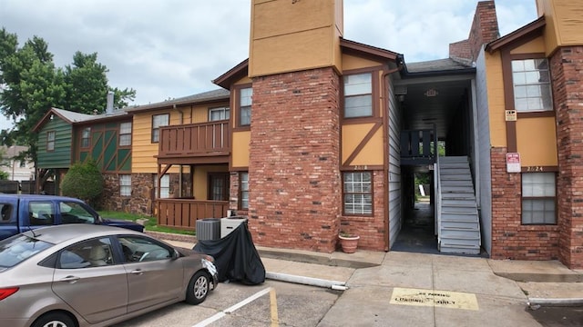 2628 N Ann Arbor Ave Unit 102, Oklahoma City, OK 73127 - view of building exterior featuring stairway and uncovered parking
