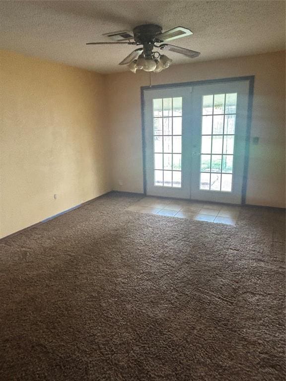 5517 S Karen St, Oklahoma City, OK 73135 - spare room with light carpet, a ceiling fan, a textured ceiling, light tile patterned floors, and french doors