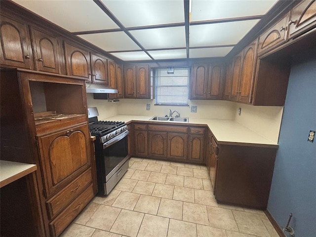 5517 S Karen St, Oklahoma City, OK 73135 - kitchen with stainless steel range with gas cooktop, under cabinet range hood, light countertops, and light tile patterned flooring