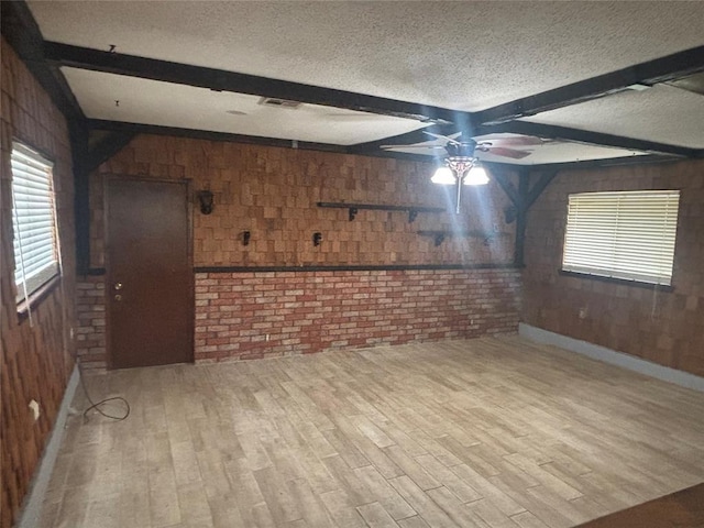 5517 S Karen St, Oklahoma City, OK 73135 - unfurnished room featuring a textured ceiling, wood walls, beam ceiling, a ceiling fan, and wood finished floors