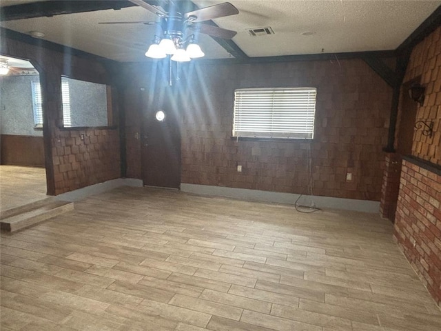 5517 S Karen St, Oklahoma City, OK 73135 - unfurnished living room featuring a ceiling fan, wood finished floors, healthy amount of natural light, and a textured ceiling