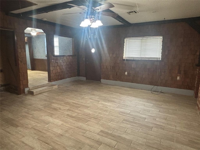 5517 S Karen St, Oklahoma City, OK 73135 - unfurnished room featuring a ceiling fan, wood finished floors, wooden walls, healthy amount of natural light, and a textured ceiling