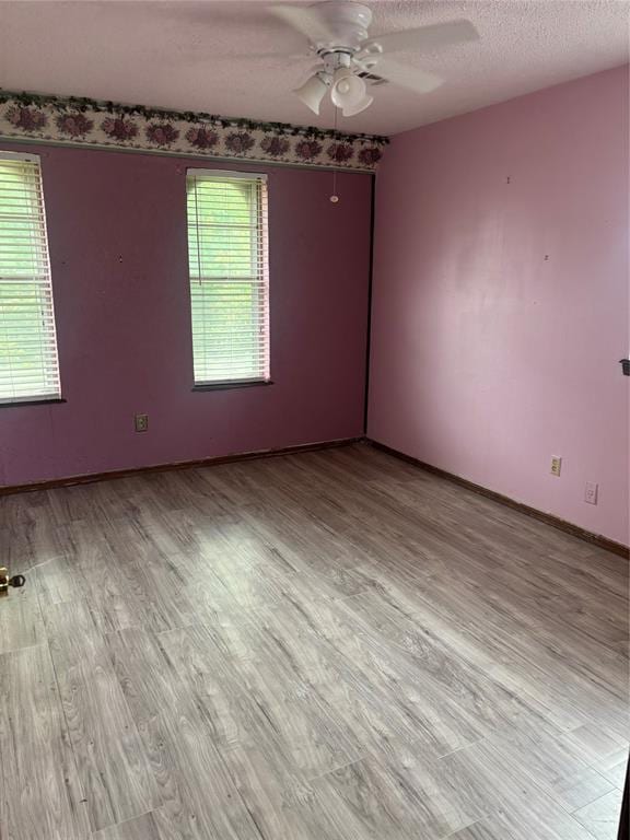 5517 S Karen St, Oklahoma City, OK 73135 - spare room featuring a ceiling fan, wood finished floors, and a textured ceiling